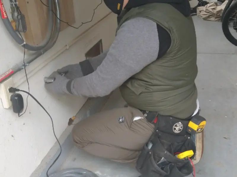 Electrician performing outlet wiring in a Millersburg garage